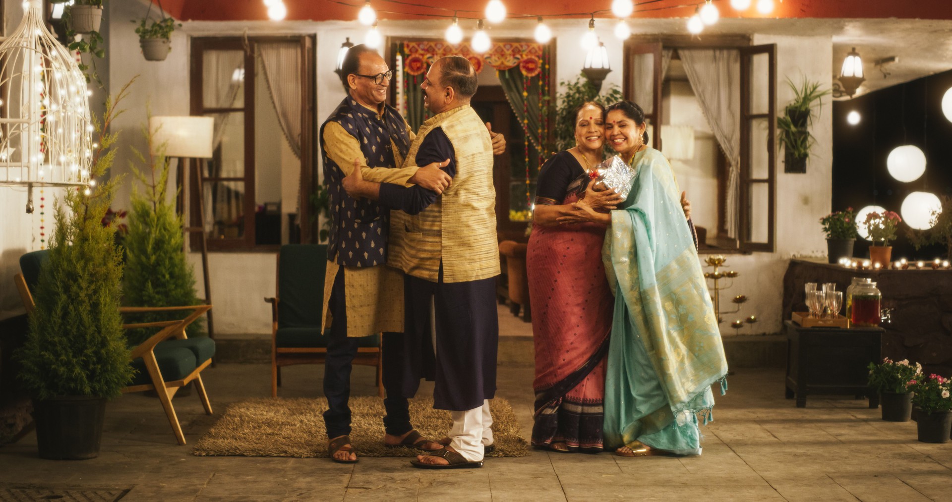 Authentic Shot of Indian Elderly Couple Receiving Family Relatives Over. Genuine Happiness in a Reunion Between Friends to Celebrate Diwali Together. Greetings, Appreciation and Gifts are Shared